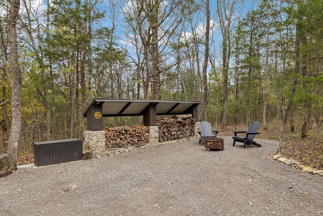 view of community featuring an outdoor fire pit