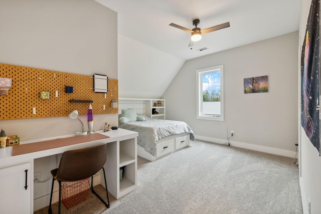 carpeted bedroom with ceiling fan and vaulted ceiling