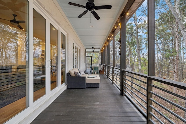 unfurnished sunroom with ceiling fan