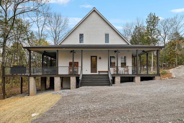 farmhouse-style home featuring ceiling fan and covered porch