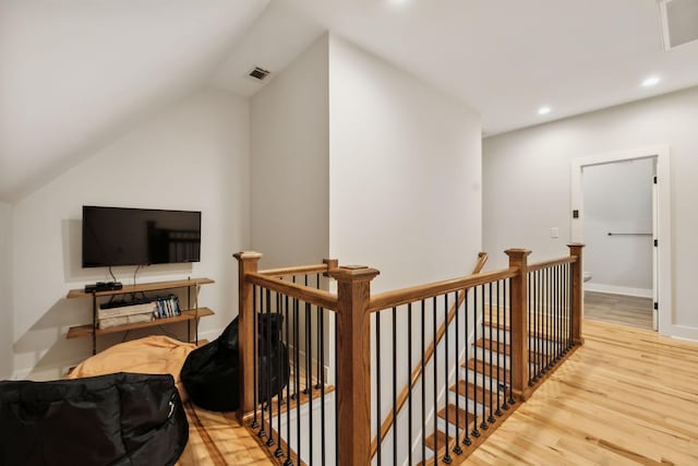 bonus room featuring light wood-type flooring and lofted ceiling