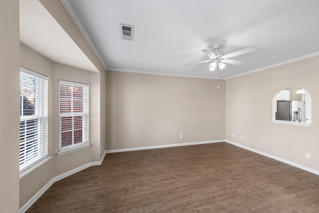 spare room with ceiling fan, crown molding, and dark hardwood / wood-style flooring