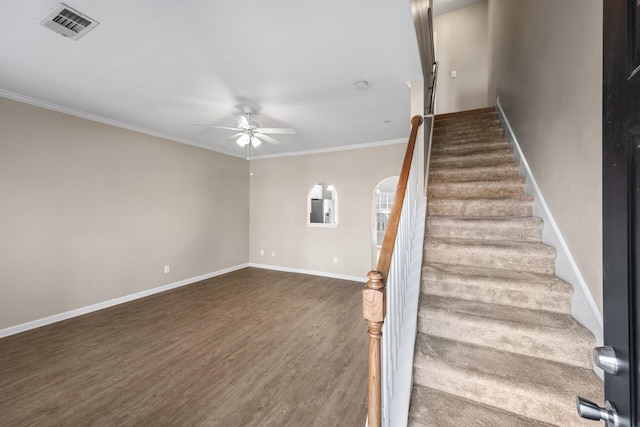 stairway with hardwood / wood-style flooring, ceiling fan, and crown molding