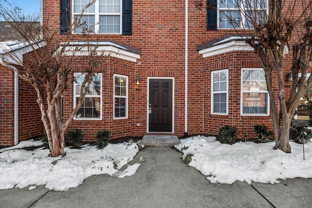 view of snow covered property entrance