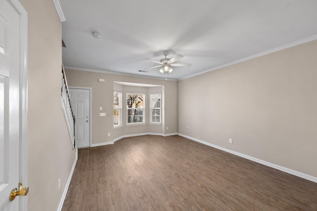 spare room with ceiling fan, crown molding, and dark hardwood / wood-style floors