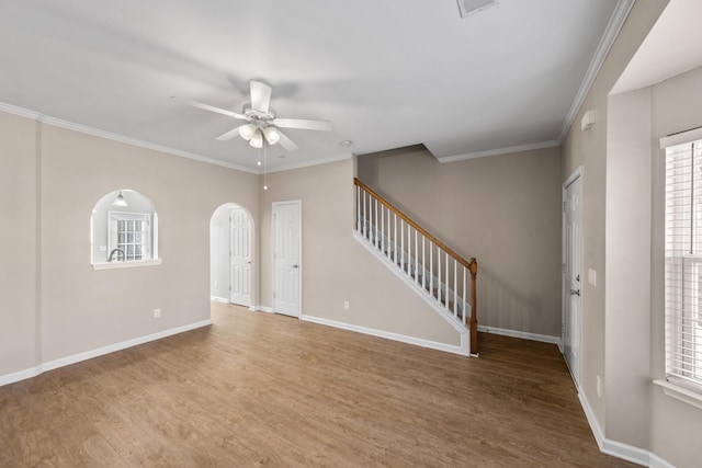 unfurnished living room featuring ceiling fan, crown molding, and hardwood / wood-style flooring