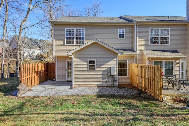 rear view of house featuring a patio and a lawn