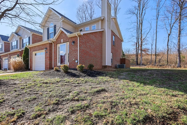 view of front of home featuring cooling unit and a garage