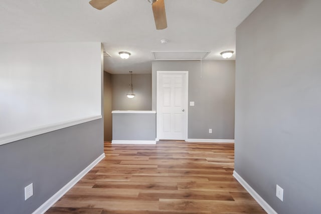 empty room with ceiling fan and light hardwood / wood-style floors