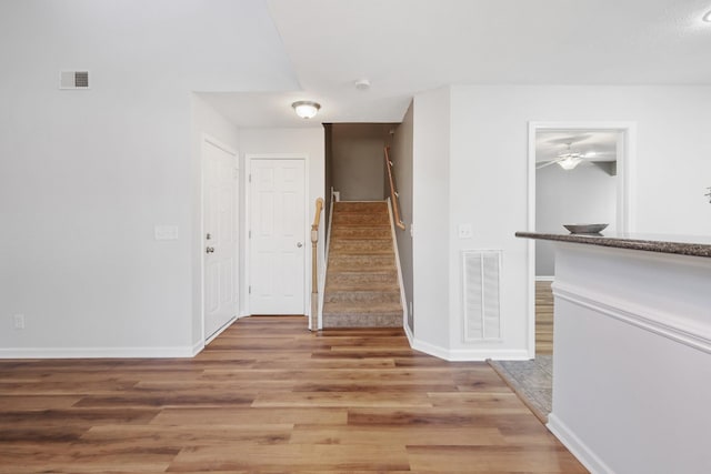 hall with hardwood / wood-style floors