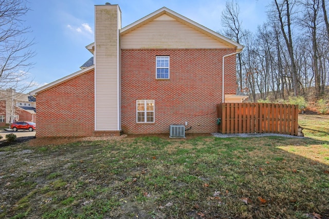 view of home's exterior with a lawn and central air condition unit