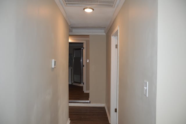 corridor with crown molding and dark hardwood / wood-style flooring