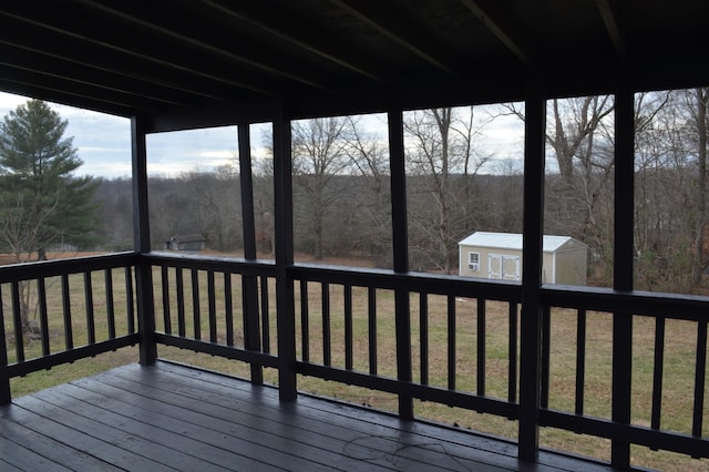 deck featuring a yard and an outdoor structure