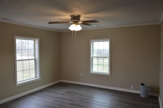 empty room featuring dark hardwood / wood-style floors, a wealth of natural light, crown molding, and ceiling fan