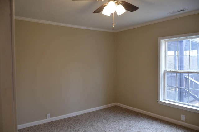 empty room featuring carpet, ceiling fan, and crown molding