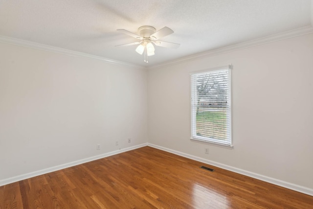 spare room featuring wood-type flooring, ceiling fan, and ornamental molding