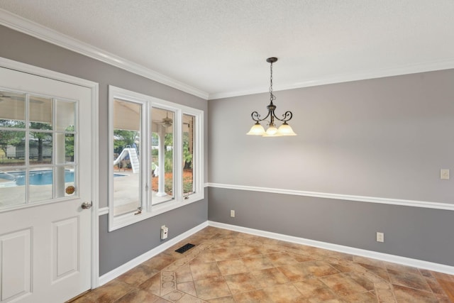 unfurnished dining area with a textured ceiling, an inviting chandelier, and crown molding