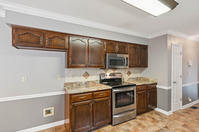 kitchen with backsplash, light stone countertops, ornamental molding, appliances with stainless steel finishes, and dark brown cabinets