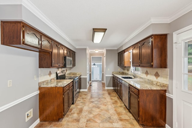 kitchen featuring decorative backsplash, light stone countertops, stainless steel appliances, crown molding, and sink