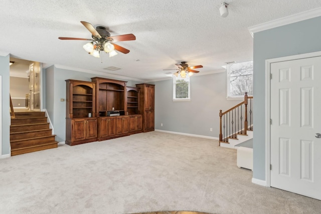 unfurnished living room featuring a textured ceiling, ceiling fan, crown molding, and light carpet