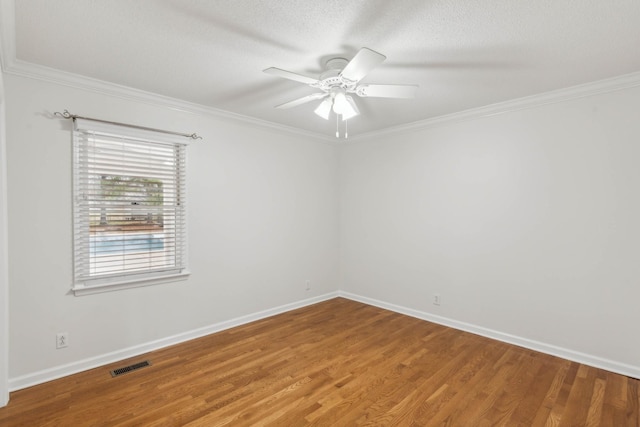 spare room featuring hardwood / wood-style flooring, ceiling fan, crown molding, and a textured ceiling