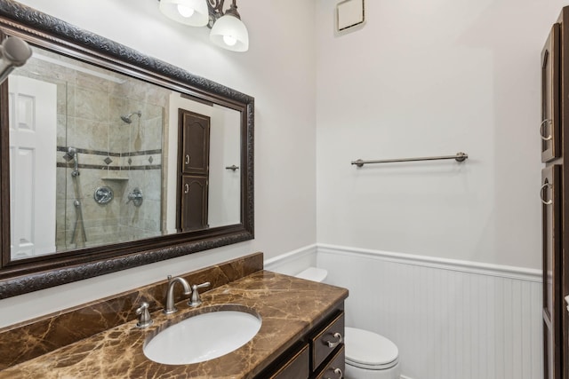 bathroom featuring vanity, an enclosed shower, and toilet