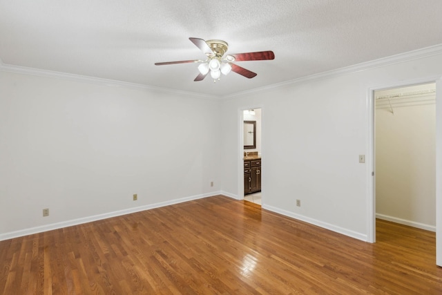 unfurnished room with crown molding, hardwood / wood-style floors, ceiling fan, and a textured ceiling