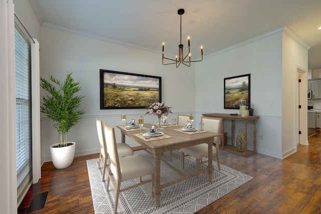 dining space with crown molding, dark hardwood / wood-style floors, a wealth of natural light, and a notable chandelier