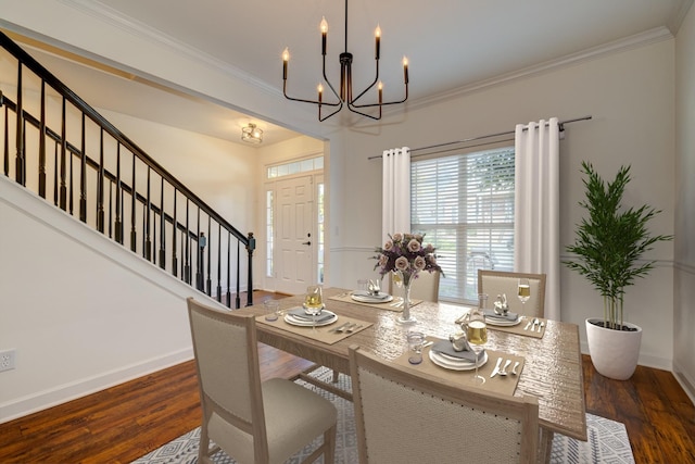 dining area featuring ornamental molding, dark hardwood / wood-style flooring, and a chandelier