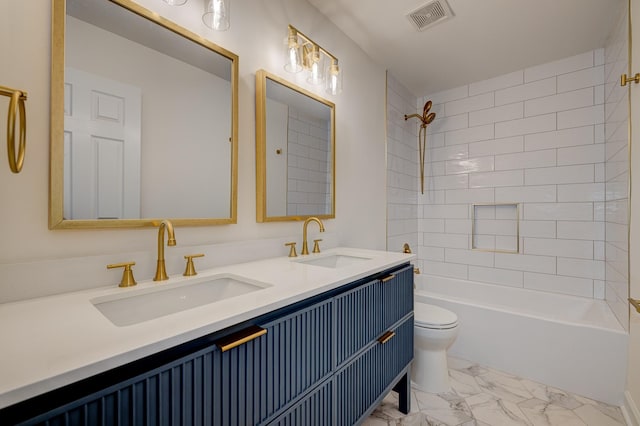 full bathroom featuring tiled shower / bath combo, vanity, and toilet