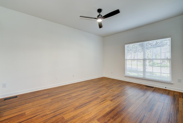 empty room featuring hardwood / wood-style floors and ceiling fan