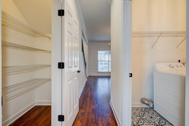 laundry room featuring dark hardwood / wood-style flooring, washer / clothes dryer, and ornamental molding