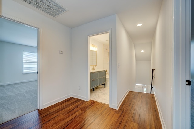 hallway with hardwood / wood-style flooring