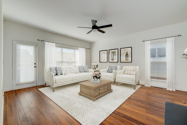 living room featuring ceiling fan and wood-type flooring