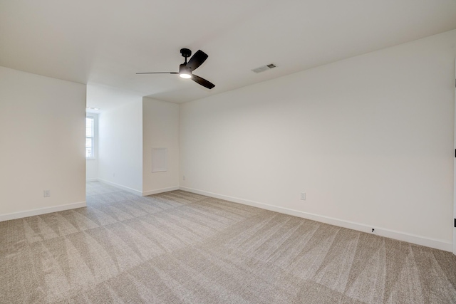 spare room with light carpet and ceiling fan