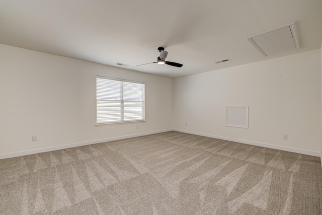 carpeted spare room featuring ceiling fan