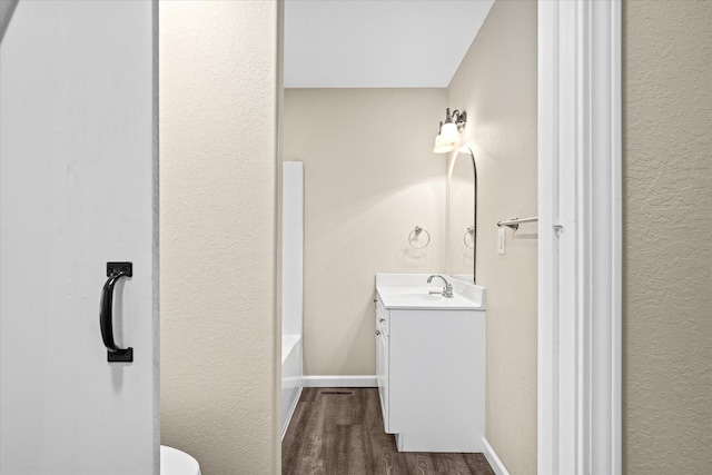 bathroom with vanity and hardwood / wood-style flooring