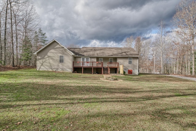 rear view of house with a deck and a yard