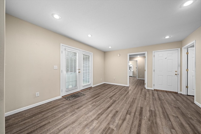 unfurnished living room featuring french doors and hardwood / wood-style flooring