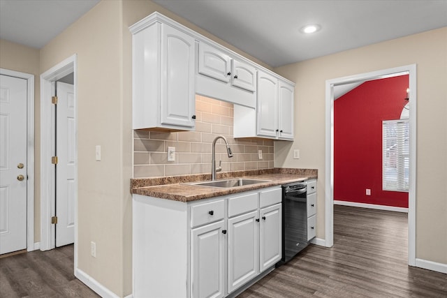 kitchen featuring black dishwasher, white cabinetry, and sink