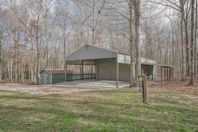 view of yard featuring a garage, a shed, and a carport