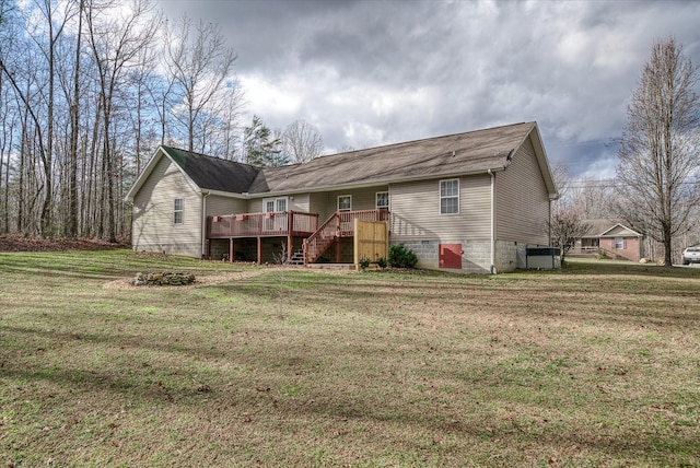 rear view of house featuring central AC unit, a yard, and a wooden deck