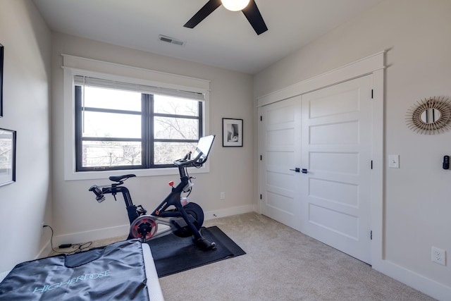 exercise area featuring ceiling fan and light colored carpet