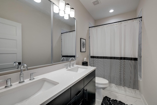 bathroom featuring tile patterned flooring, vanity, and toilet