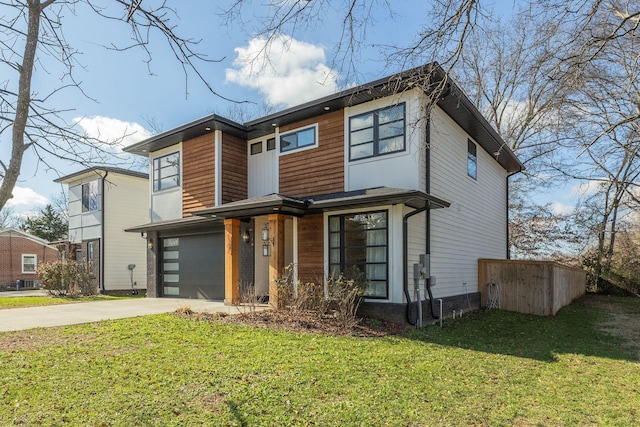 contemporary house featuring a garage and a front lawn