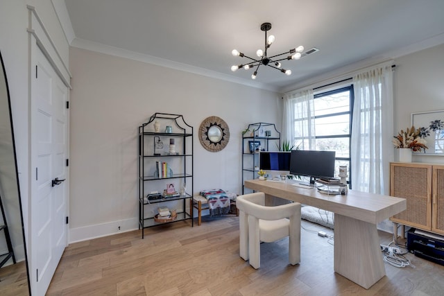 office space with light wood-type flooring, ornamental molding, and an inviting chandelier