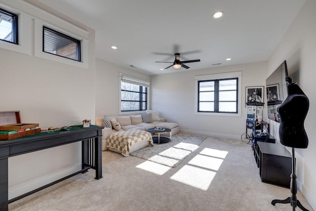 interior space with ceiling fan and light colored carpet