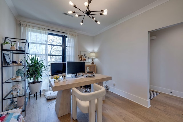 office space featuring a notable chandelier, ornamental molding, and light hardwood / wood-style flooring