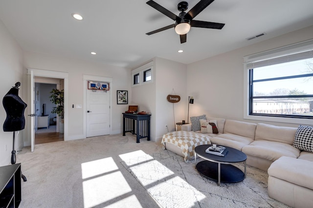 living room with ceiling fan and light carpet