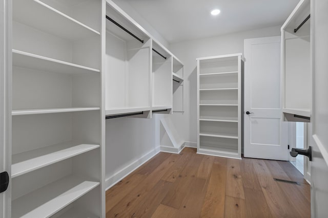 spacious closet featuring light wood-type flooring